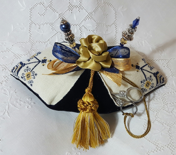 blue and gold pincushion pillow